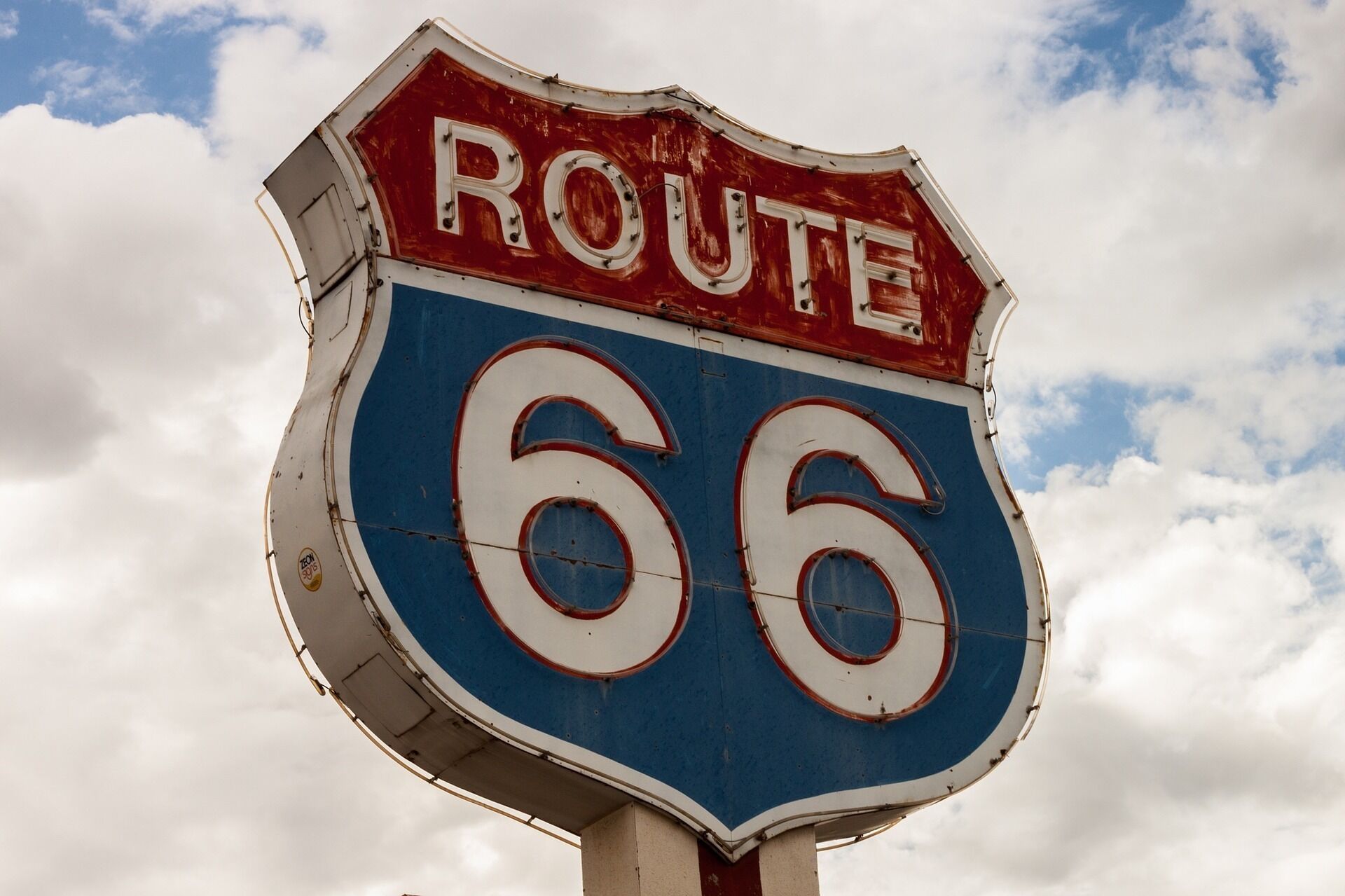 A Route 66 sign with a blue and red shield shape.