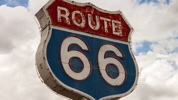 A Route 66 sign with a blue and red shield shape.