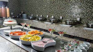 A buffet with various food items and beverages.