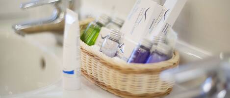 A bathroom sink with a wicker basket containing various toiletries.