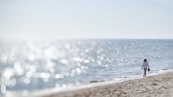 Walking along the beach, guests can enjoy the serene atmosphere and stunning views.