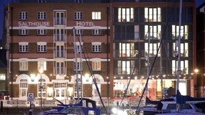 A hotel with a prominent sign reading "SALTHOUSE HOTEL" and a dock with boats. - Salthouse Harbour Hotel and Spa (Ipswich)