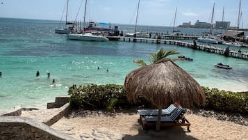 On the beach, white sand, sun-loungers, beach umbrellas
