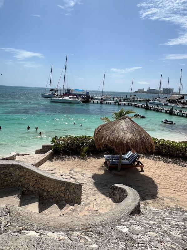 On the beach, white sand, sun loungers, beach umbrellas