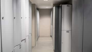 A hallway with lockers numbered 1 to 46, leading to a door at the end.