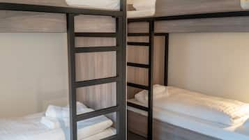 A bunk bed room with wooden frames and white bedding.