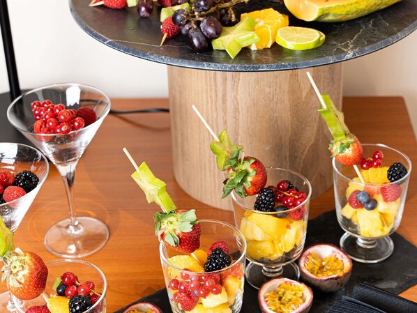 A fruit platter with various fruits and a decorative centerpiece.