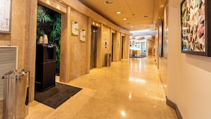 Un pasillo de hotel con recepción, bar y comedor.