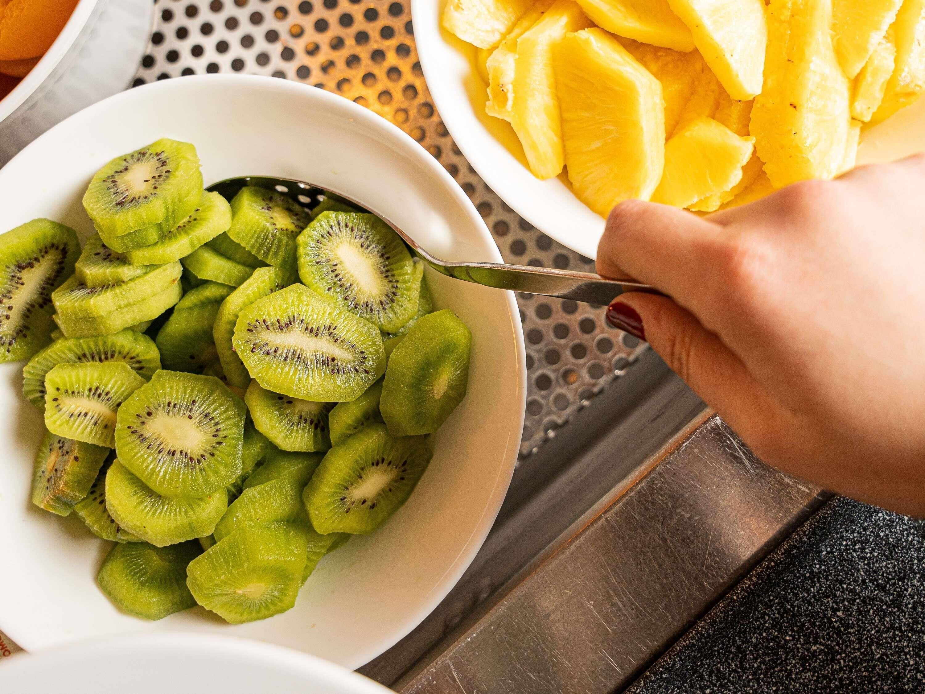 Una ciotola con kiwi e ananas a fette.
