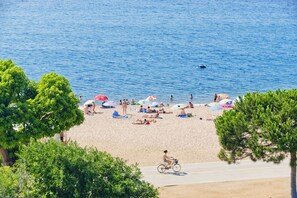 Beach nearby, white sand, beach umbrellas, beach towels