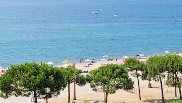 Beach nearby, white sand, beach umbrellas, beach towels