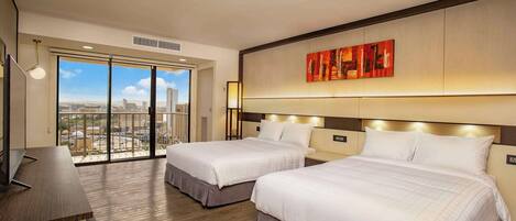 A hotel room with two beds, a desk, and a large window offering a city view.