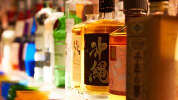 A variety of liquor bottles with labels, arranged on a table.