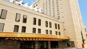 A hotel with a prominent Rembrandt sign, multiple windows, and a modern architectural design.