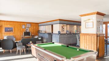 Relax in a well-appointed room with a pool table, comfortable seating area, and TV.