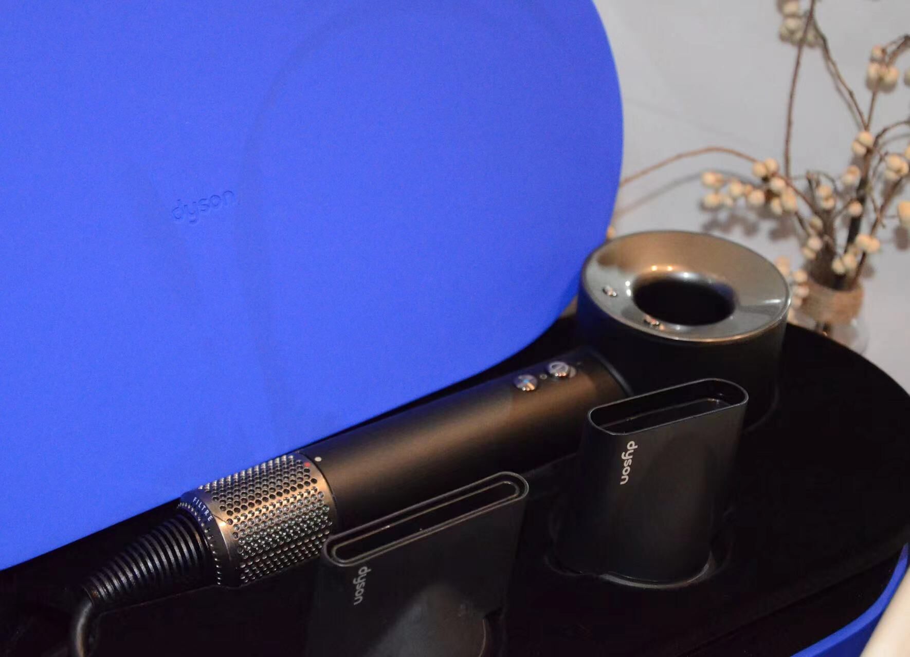 A microphone and audio equipment on a black surface with a blue background.