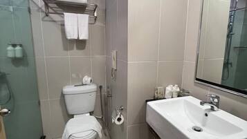 A modern bathroom with a toilet, bidet, and sink.