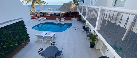 Outdoor pool, open 7 AM to 10 PM, pool umbrellas, sun loungers