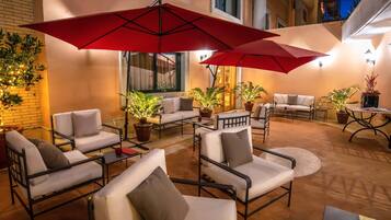 Relax in style with comfortable seating and lush greenery.