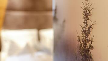 A blurred view of a room with a brown couch and a plant in the foreground.