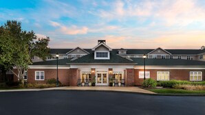 A two-story brick building with a flat roof and a central entrance.