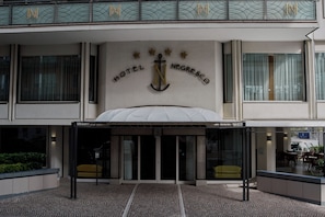 The entrance to Hotel Negresco with a prominent anchor logo, double doors, and a covered entrance area. - Hotel Negresco (Cattolica)