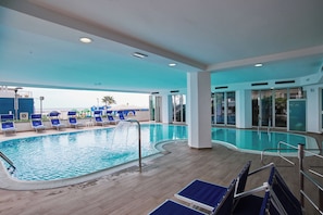 Indoor pool, open 8:00 AM to 7:00 PM, pool loungers