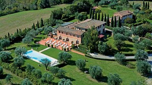 An aerial view of a large estate with a swimming pool, multiple buildings, and extensive landscaping. - Hotel Borgo Casato (Castelnuovo Berardenga)