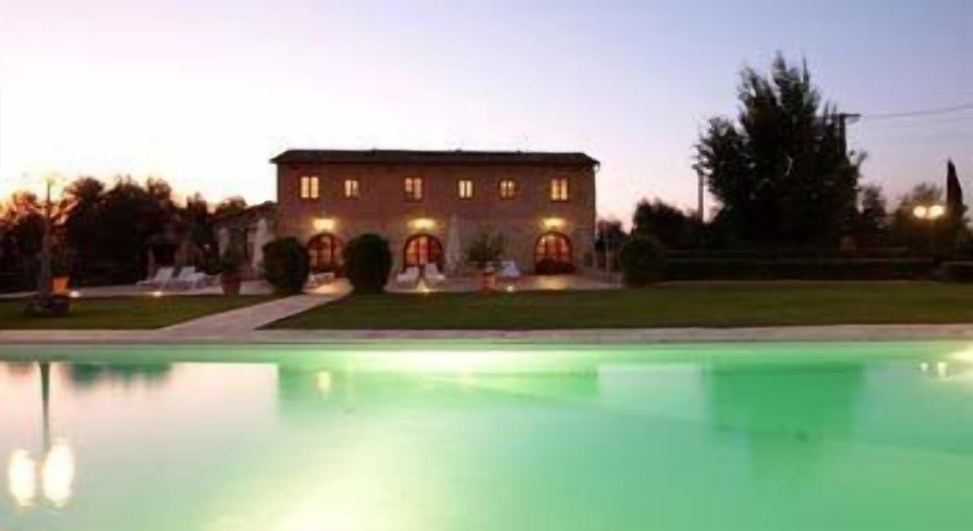 A building with a swimming pool in front.