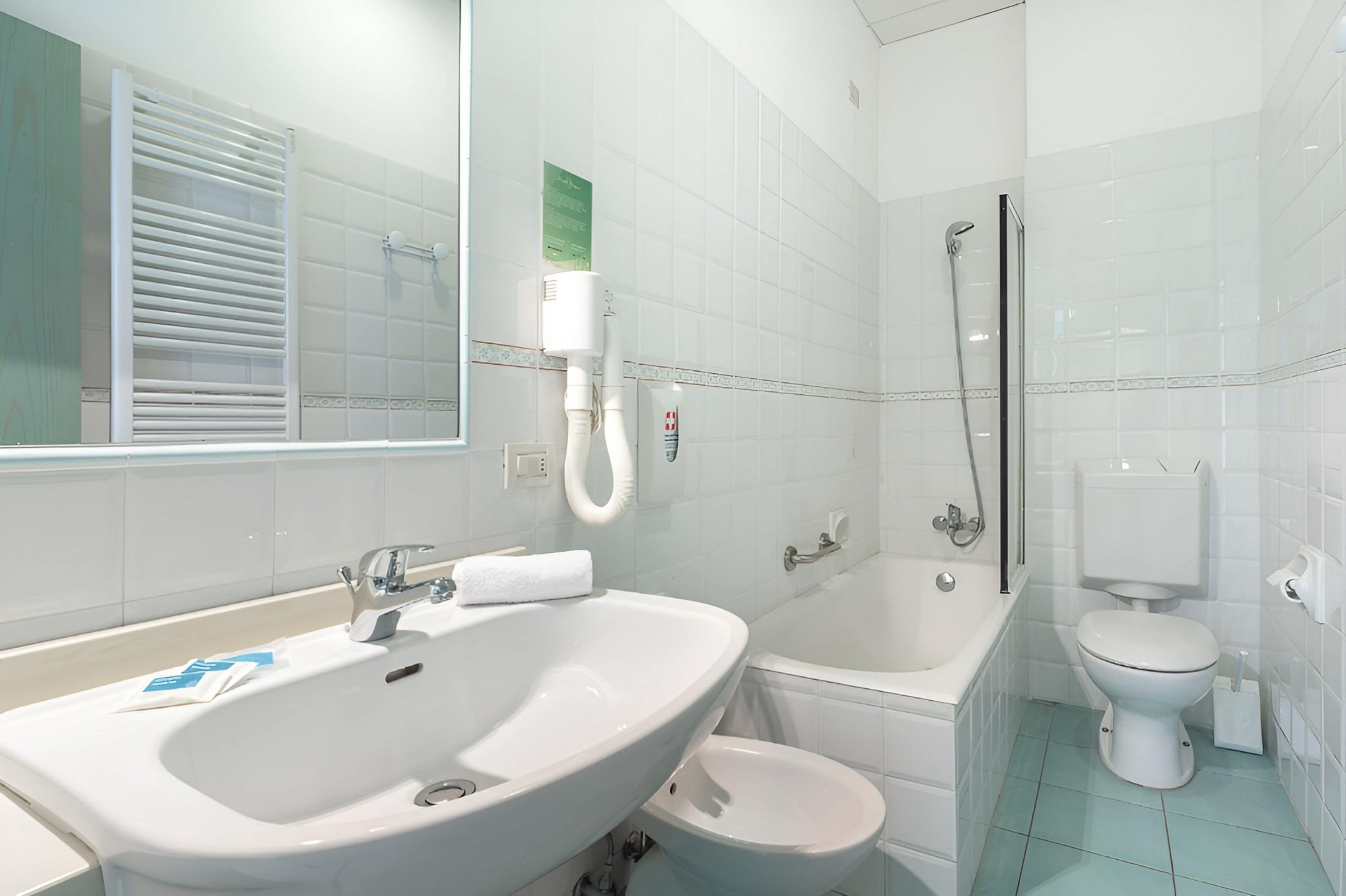 Un bagno moderno con un lavandino capiente, una vasca, un water e una doccia.