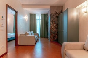 Junior Quadruple Room | Living area | 72-inch TV with digital channels