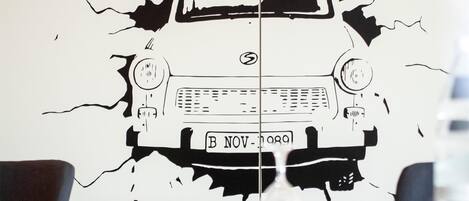 A wall with a car illustration that appears to be breaking through.