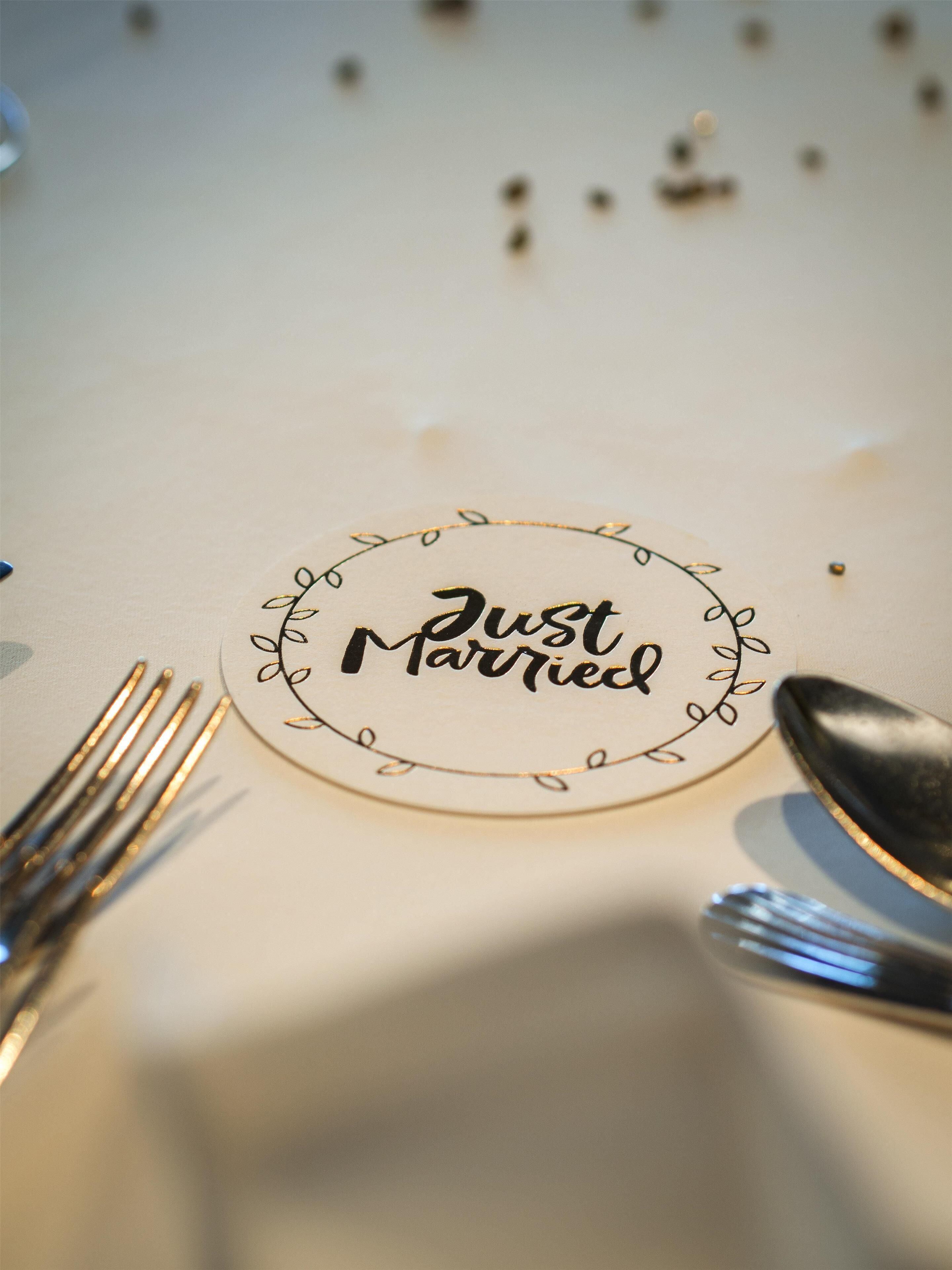 A table with a 'Just Married' sign, a spoon, and a fork.