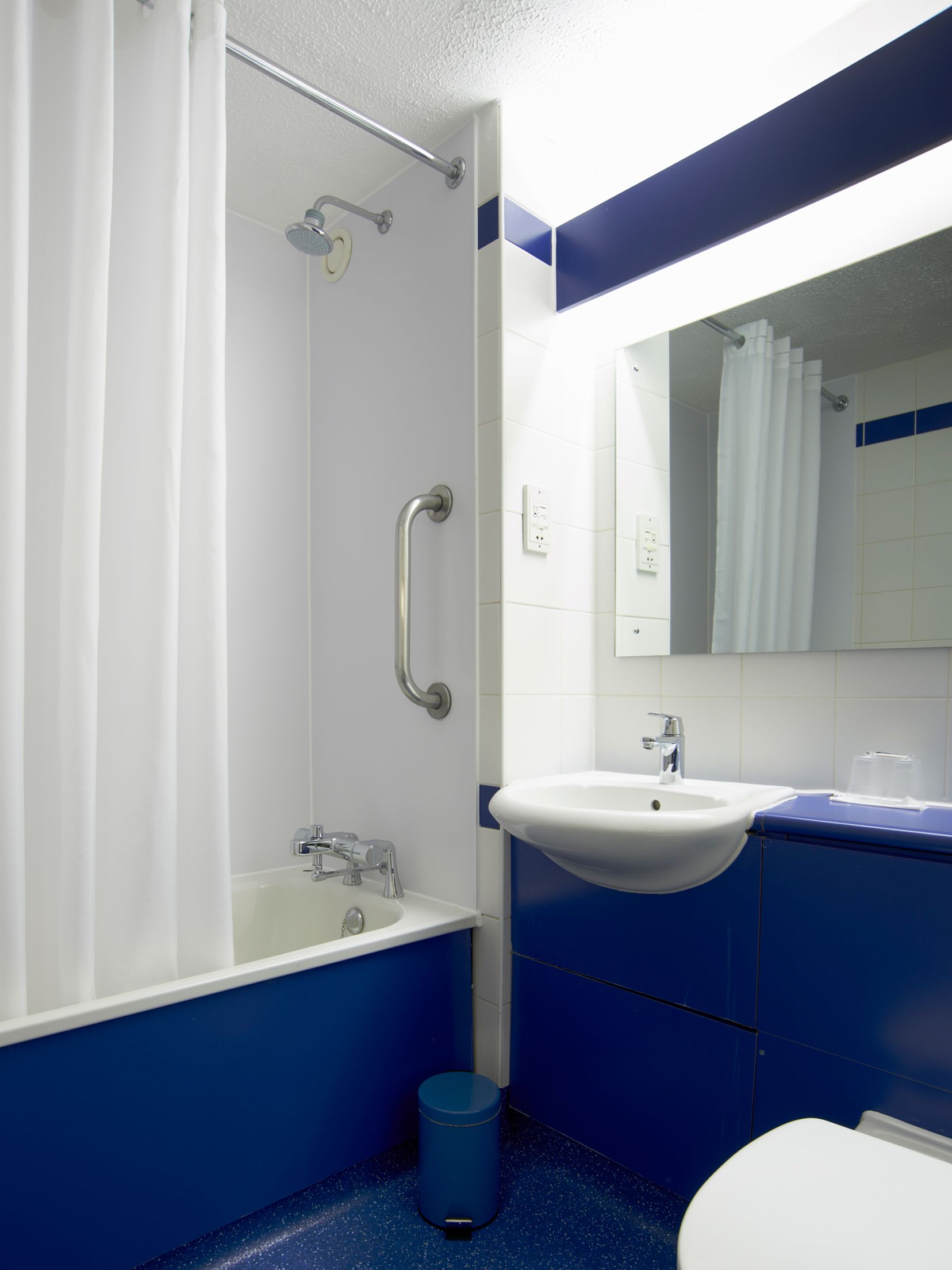 A bathroom with a bathtub, a sink, and a toilet.