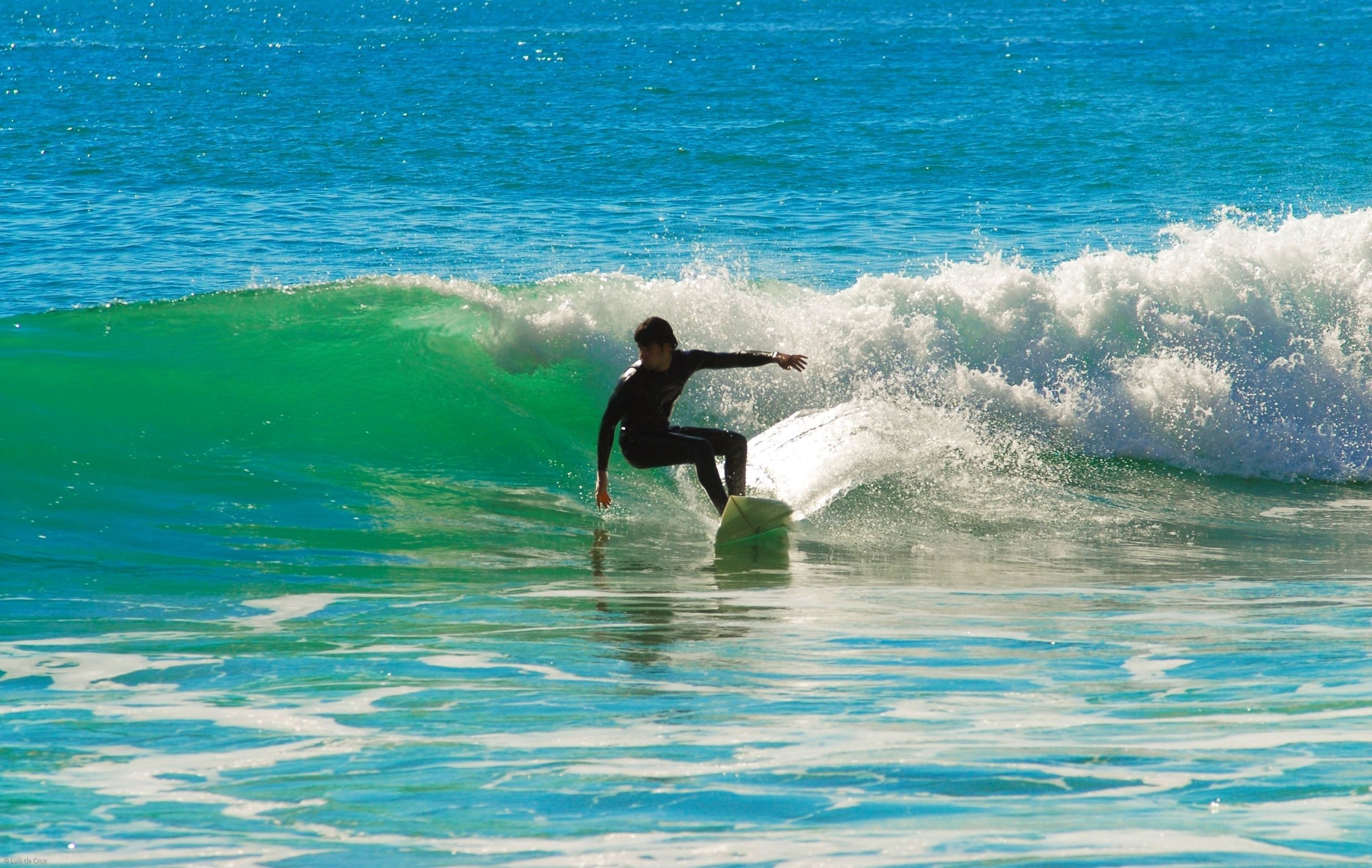 A surfer riding a wave in the ocean.