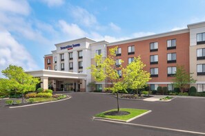 A hotel with a modern brick facade, a covered entrance, and landscaped areas with young trees. - SpringHill Suites by Marriott Cleveland/Solon (Solon)