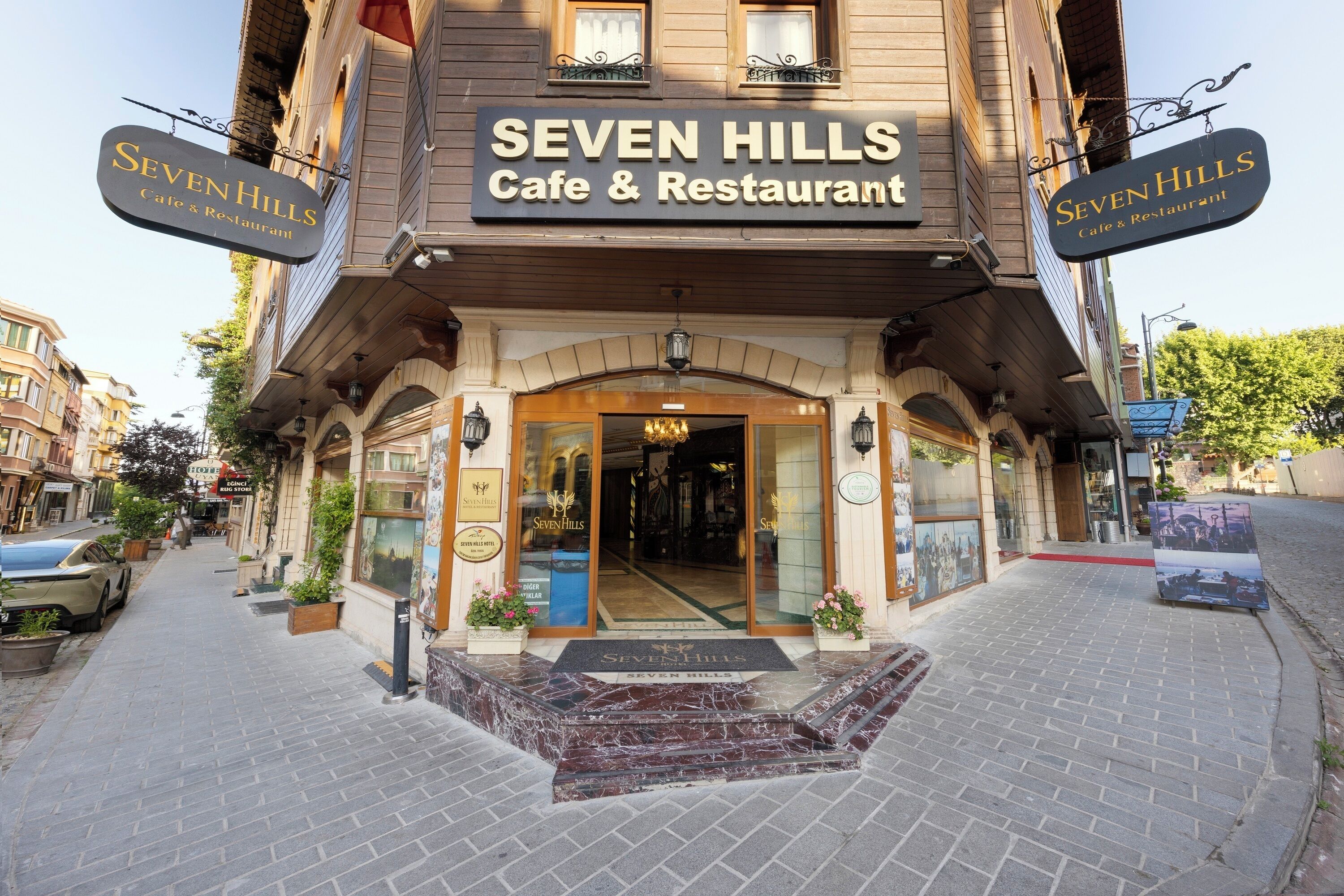 A building with a sign reading 'SEVEN HILLS Cafe & Restaurant' at the entrance.