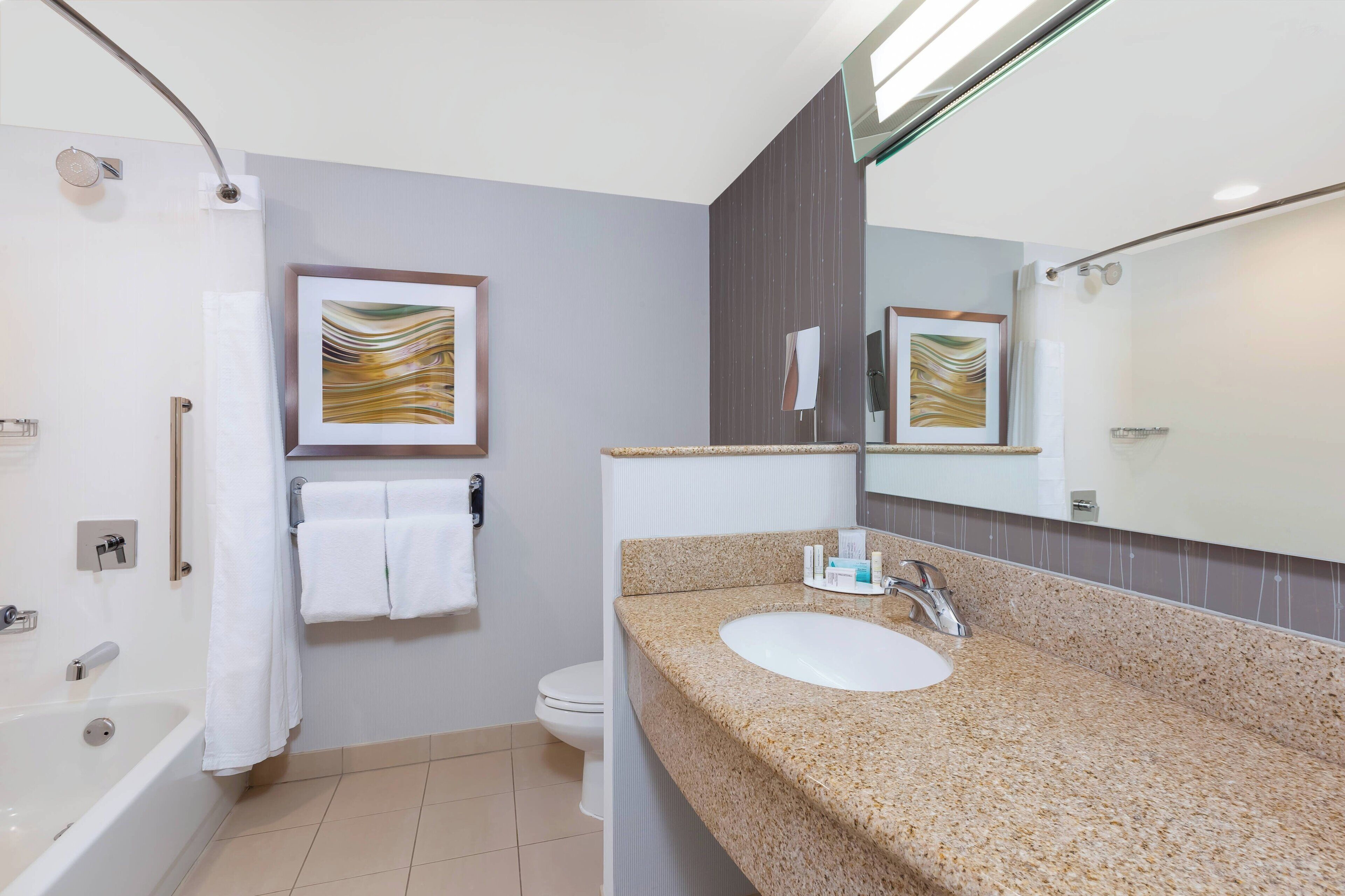 combined shower/bathtub, designer toiletries, hair dryer, towels