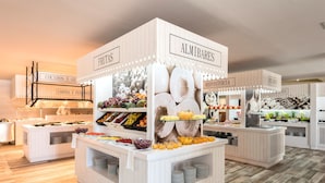 A buffet setup with labeled sections for fruits, vegetables, and dairy products.