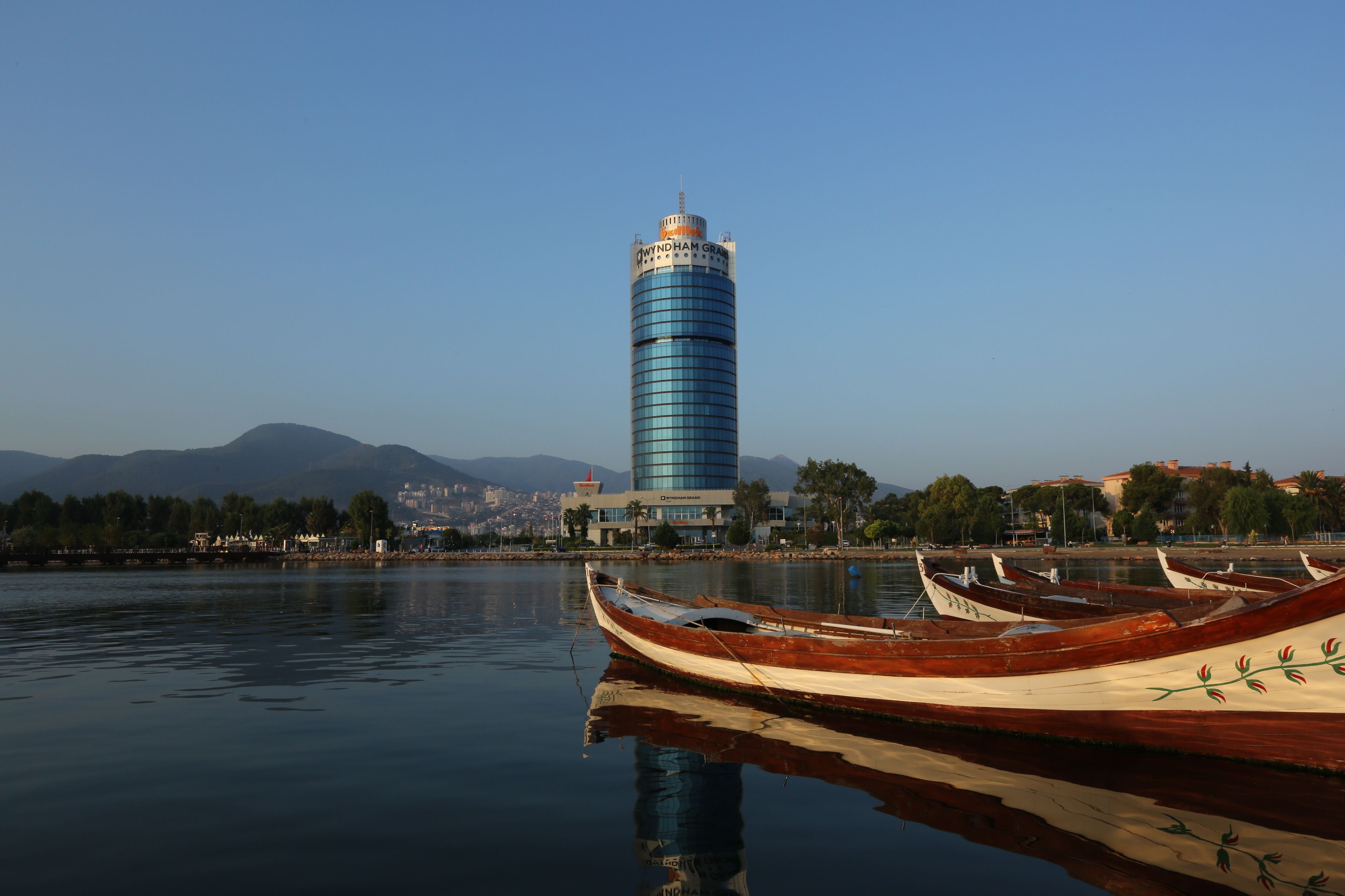 Vista al agua con un edificio alto y varios barcos.