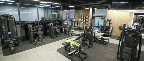 A gym with various exercise machines, treadmills, and weightlifting equipment.