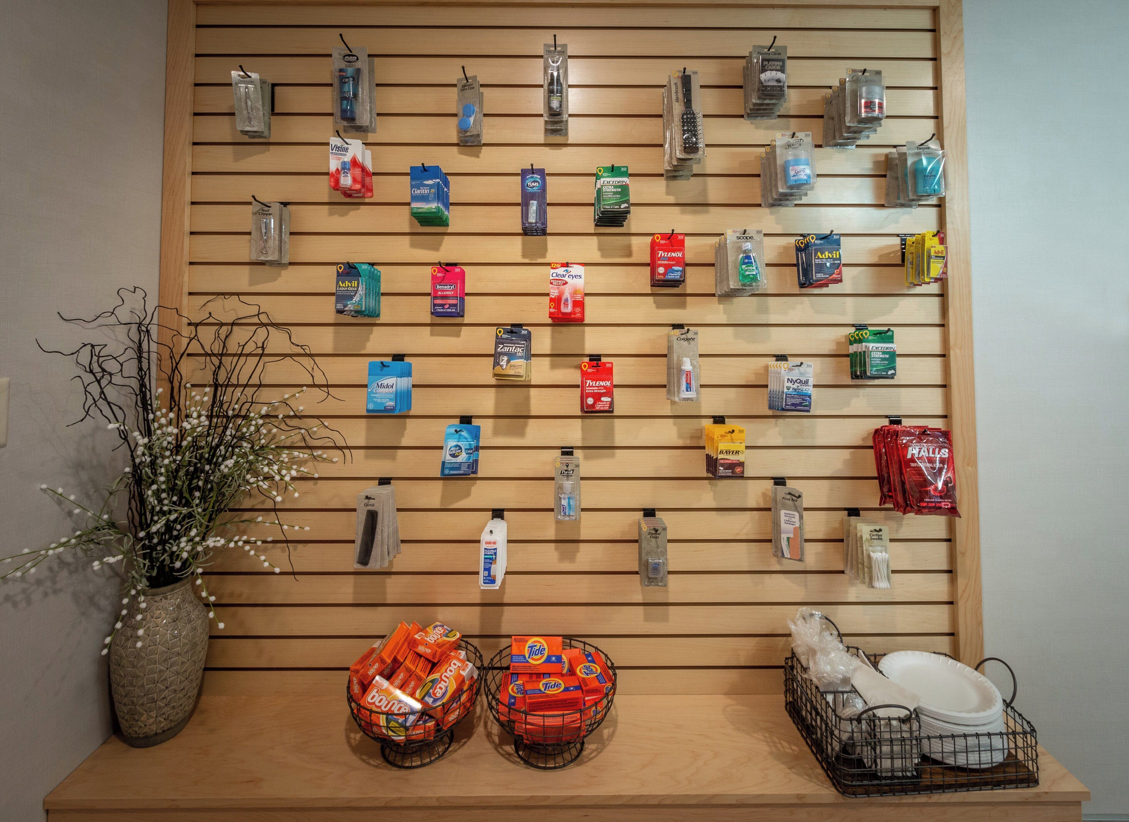 A wall-mounted display of various toiletries and cleaning products.