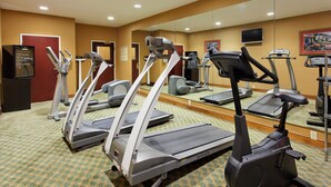 A hotel fitness center with multiple treadmills, ellipticals, and a mirrored wall. - Holiday Inn Express Hotel & Suites Tupelo by IHG (Tupelo)
