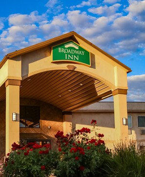 A building with a sign reading "Broadway Inn" and a covered entrance.