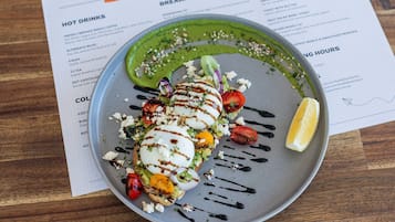 Um menu com diversas opções de comida, incluindo café da manhã e bebidas quentes.