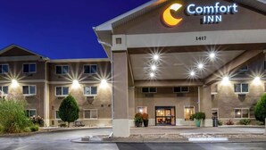 A Comfort Inn hotel with a modern facade, multiple windows, and a well-lit entrance.