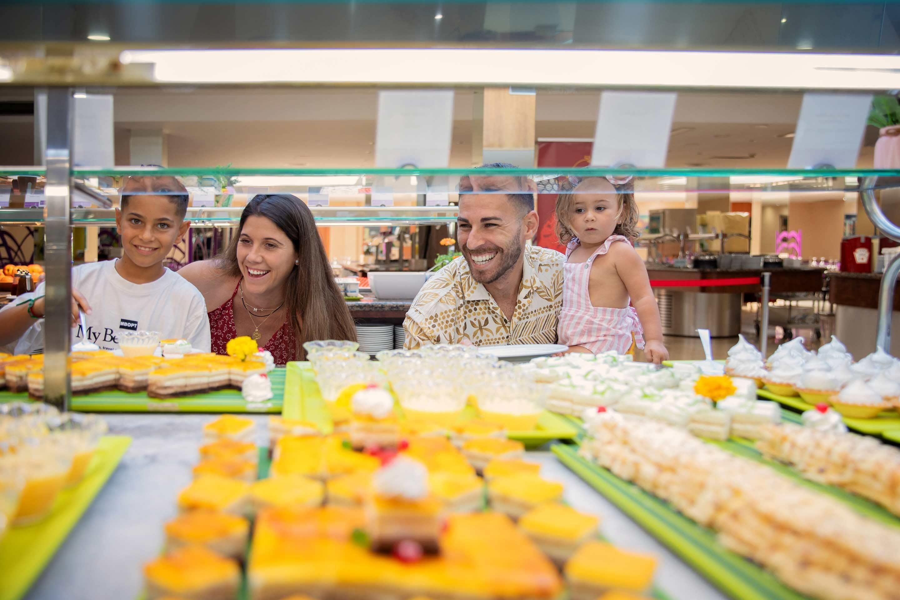 A buffet with various food items and a glass display case.