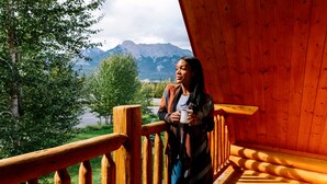 A wooden balcony with a view of a lake and mountains. - Miette Mountain Cabins (Pocahontas)