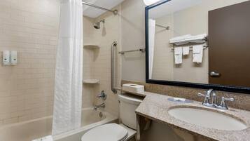 A bathroom with a bathtub, toilet, sink, and a shower with a curtain.