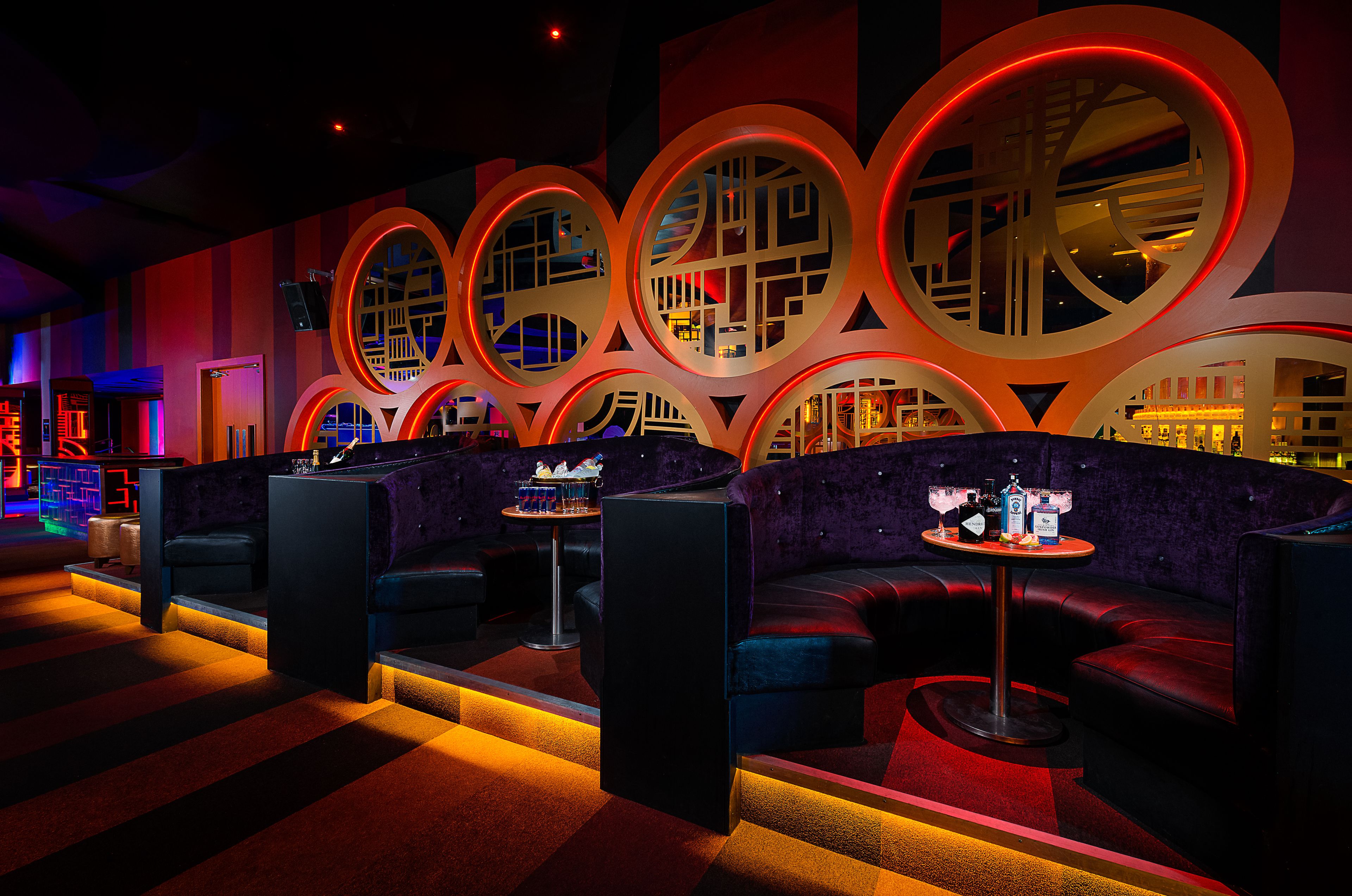 A modern lounge area with seating and a bar.